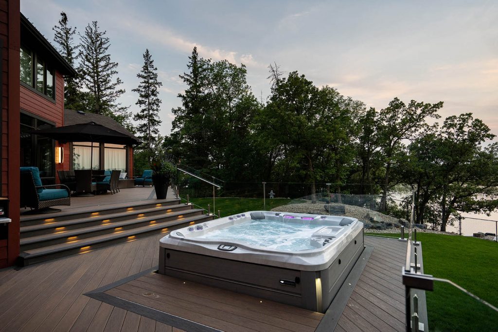 windeck designed three level deck overlooking river with hot tub and wolf pvc decking